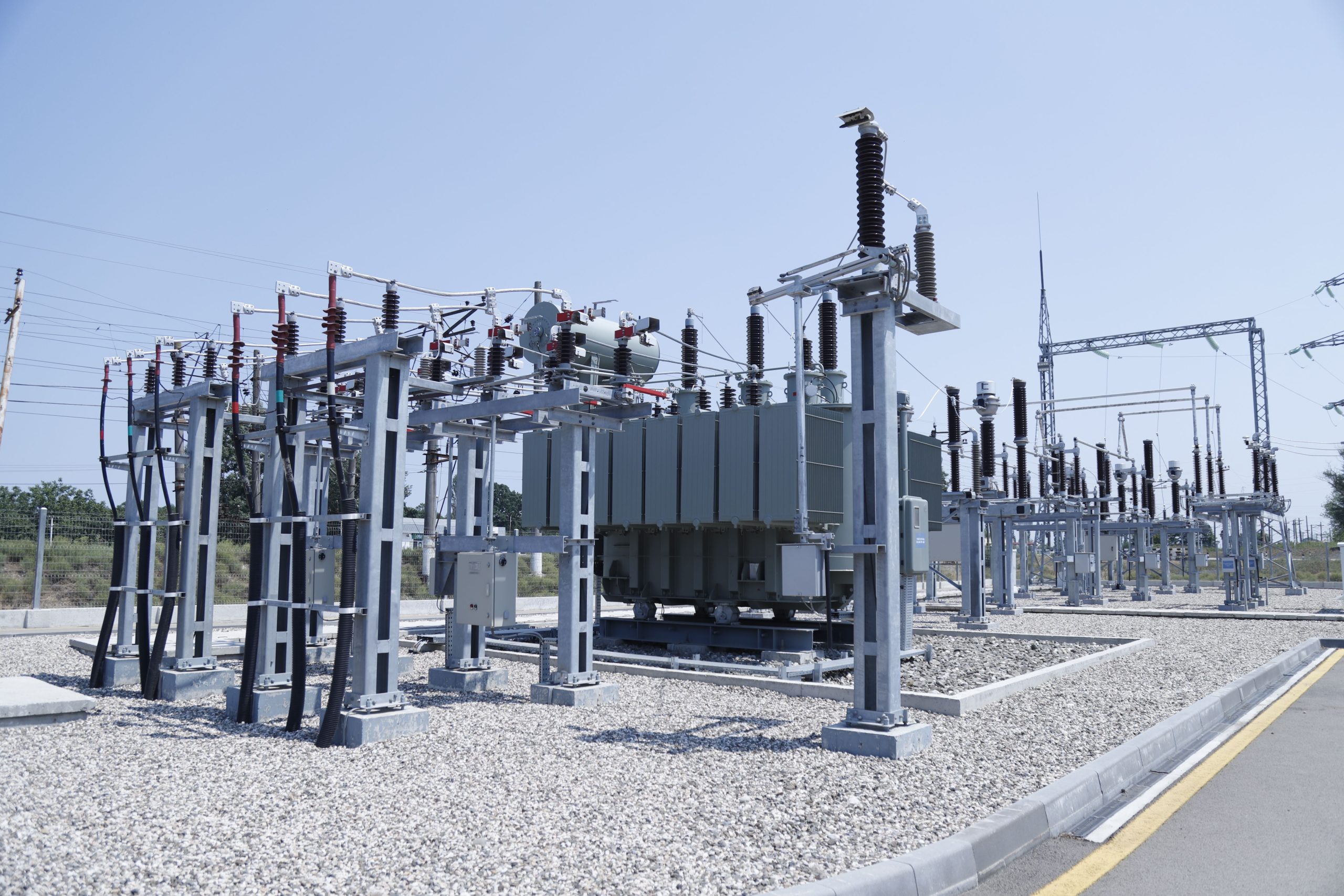 An aerial view of electrical substation under blue sky