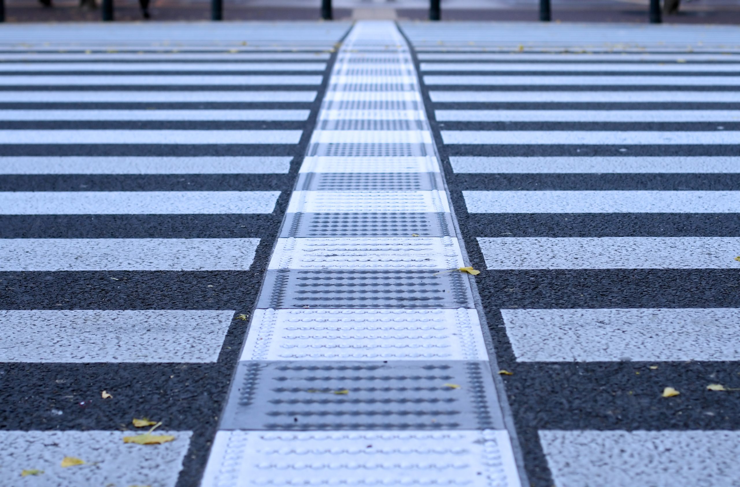 Very low perspective and selective focus of a pedestrian crossing generating an interesting urban abstract.